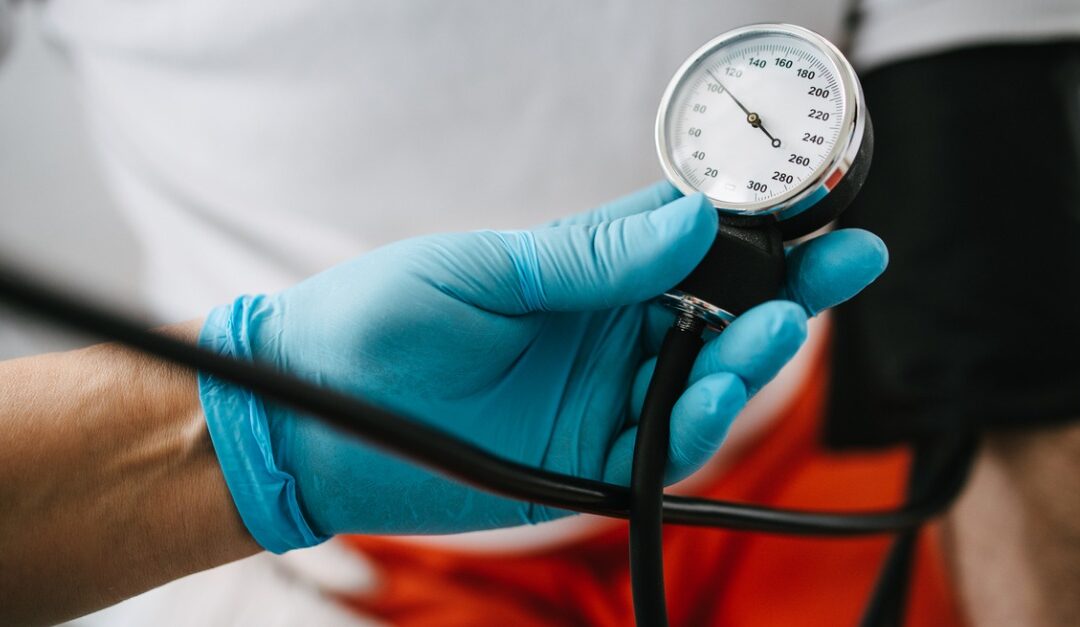 Doctor holding blood pressure meter