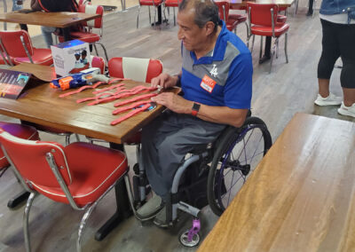 A man in a wheelchair, going through raffle tickets.