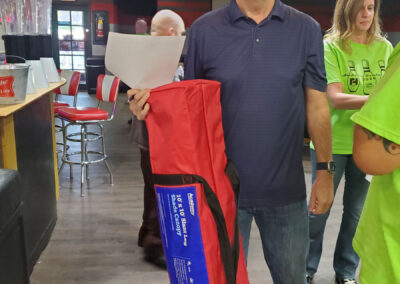 A man holding a shade canopy in a case.