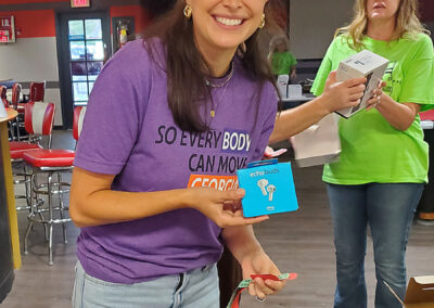 A woman holding Amazon echo buds.