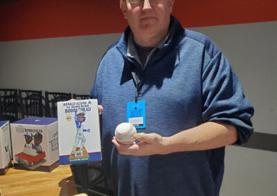 A man showing off a Ronald Acuña Jr. bobblehead.