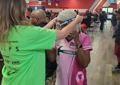 A lady placing a Champion medal on another female.