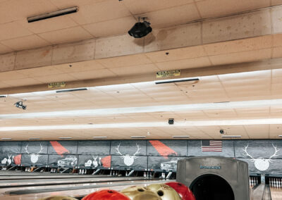 A shot of a bowling lane and bowling balls.