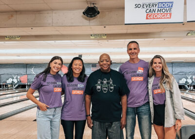 A group of So Everybody Can Move Georgia attendees with a man with prosthetic legs.