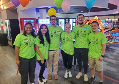 A group of 6 people smiling at the Bowler Bash 2024.